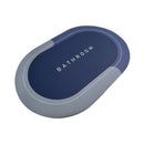 Rectangular blue and gray bath mat with 'BATHROOM' text on a white background