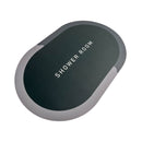 Black oval device with 'SHOWER ROOM' text on a white background