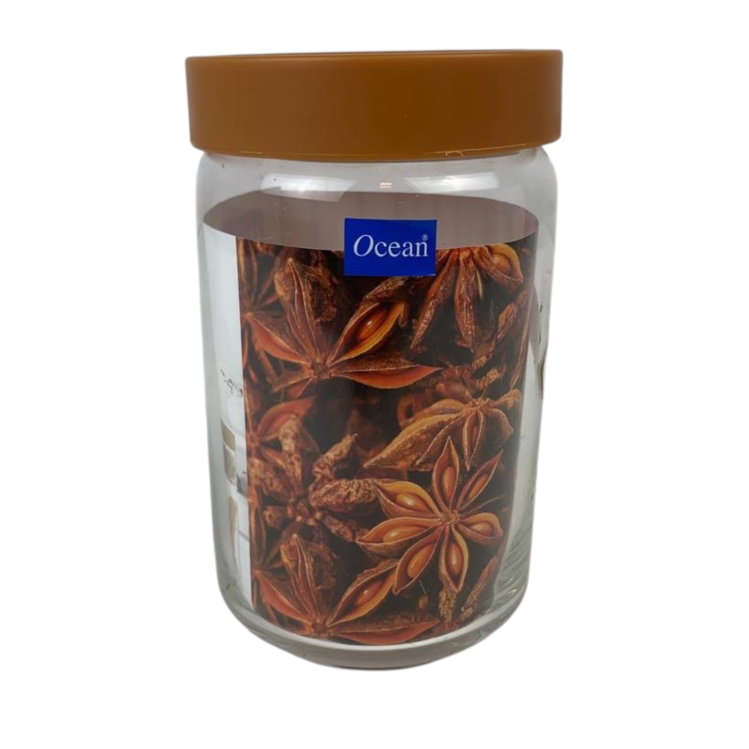 Glass jar with star anise and a brown lid on a white background