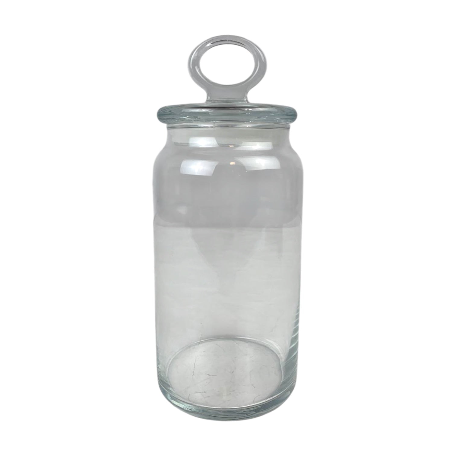 Clear glass jar with a metal lid on a white background