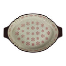 Decorative oval platter with red snowflake pattern on a white background