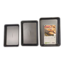 Set of three rectangular baking trays with a package labeled 'GreenPan' on a white background.