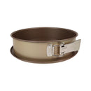 Brown springform pan with a silver release clip on a white background