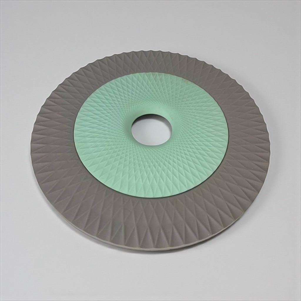 Disc with green center and gray rim on a light gray background available at cupindy.com