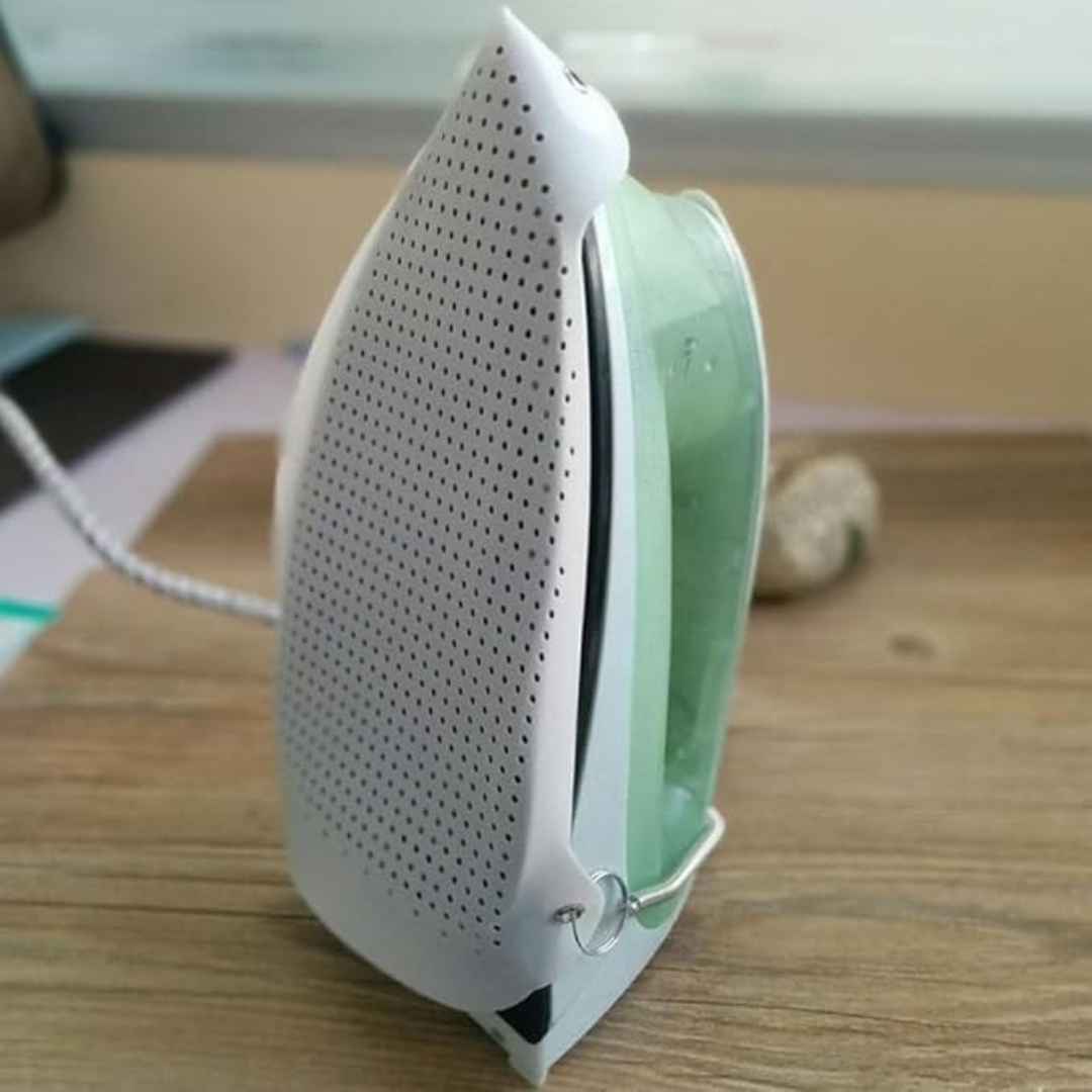 White and green electronic device on a wooden surface