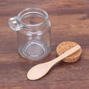 Honey jar with airtight cork lid and wooden dipper for serving