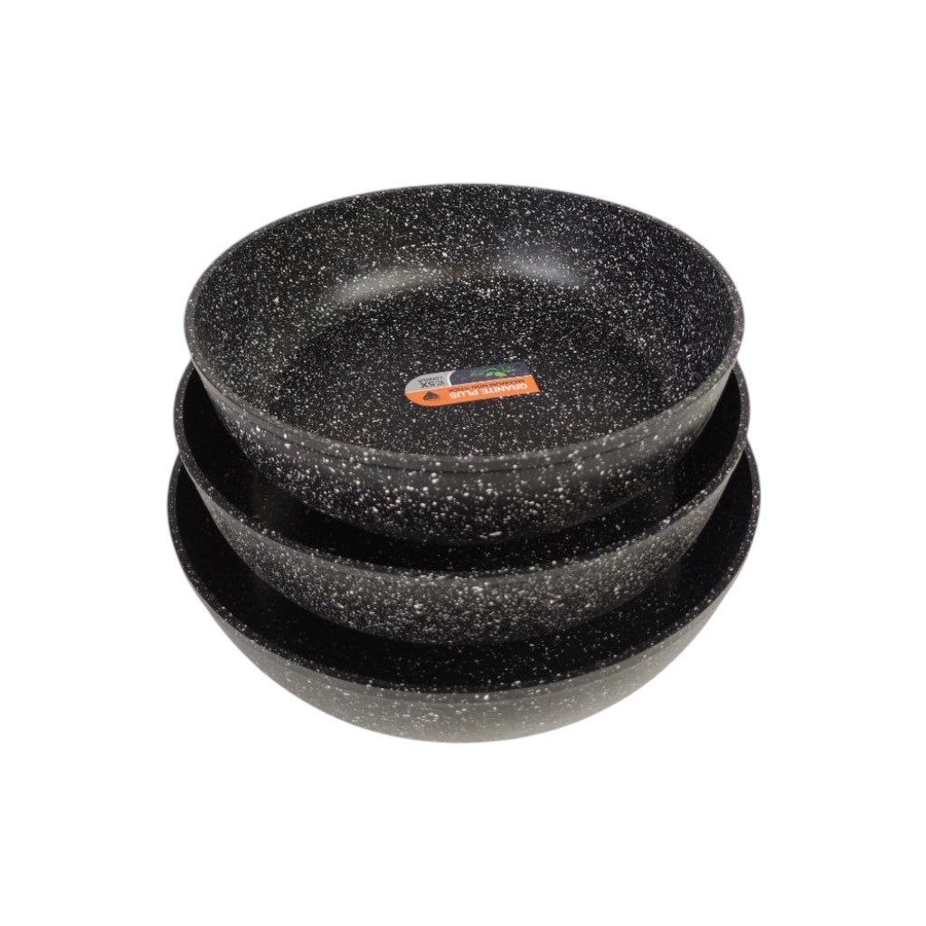 Set of three black speckled bowls stacked on a white background