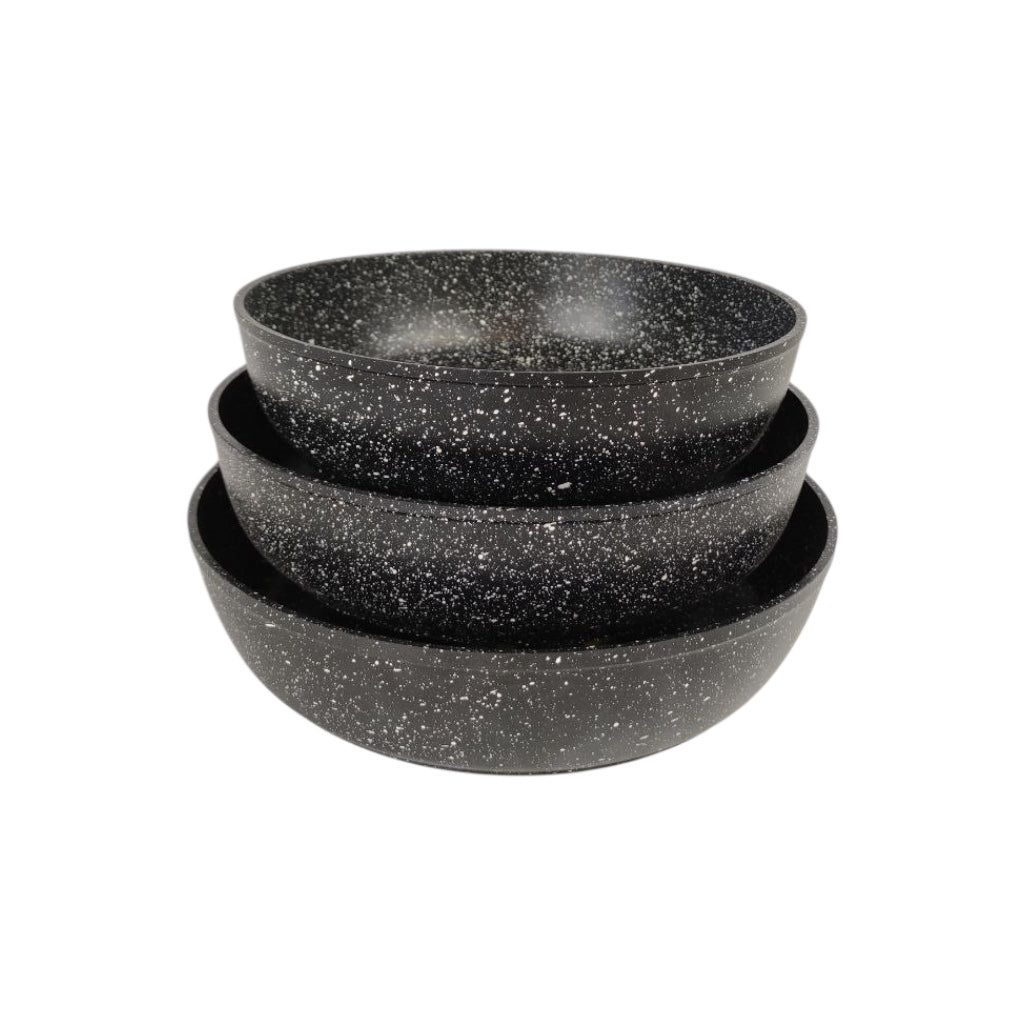 Set of three black speckled bowls stacked on a white background