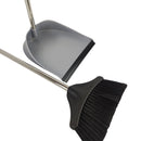 Gray dustpan and black broom with metal handles on a white background