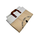 Folded white garment inside a beige bag with text on a white background