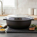 Black cookware set with glass lid on a kitchen counter