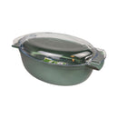 Green glass bowl with a clear lid on a white background