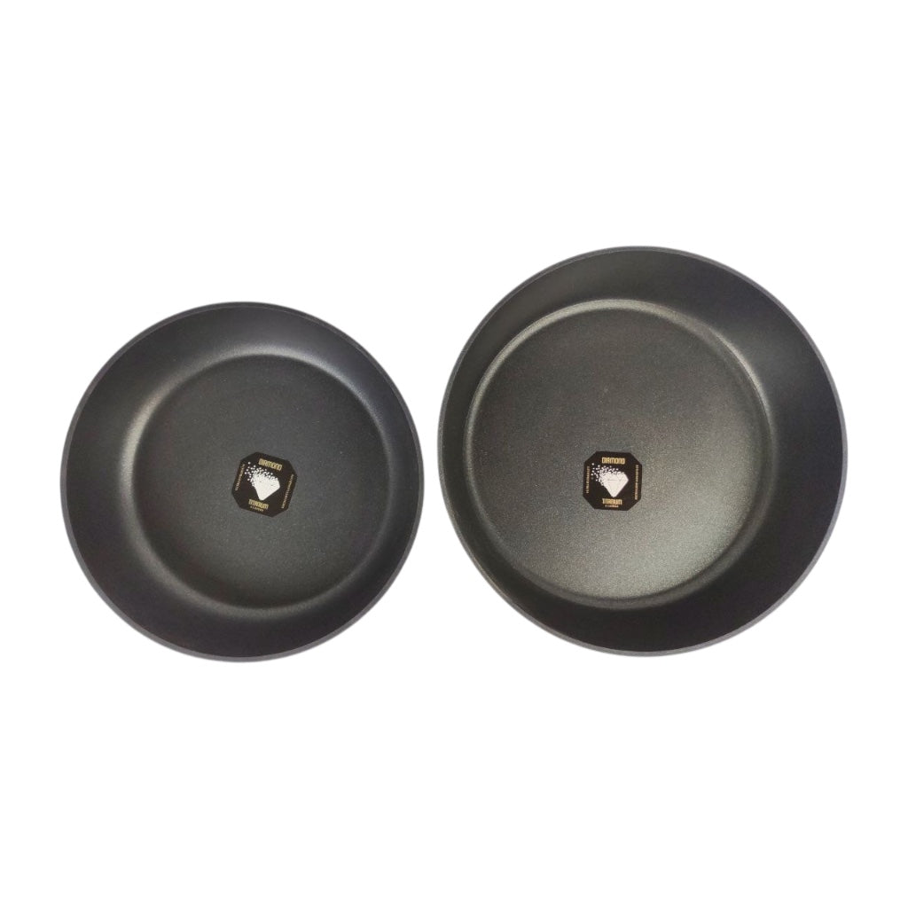 Two black frying pans on a white background