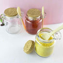 Compact glass spice jar with natural wooden spoon for kitchen use