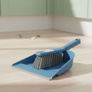 Blue dustpan and brush set on a wooden floor