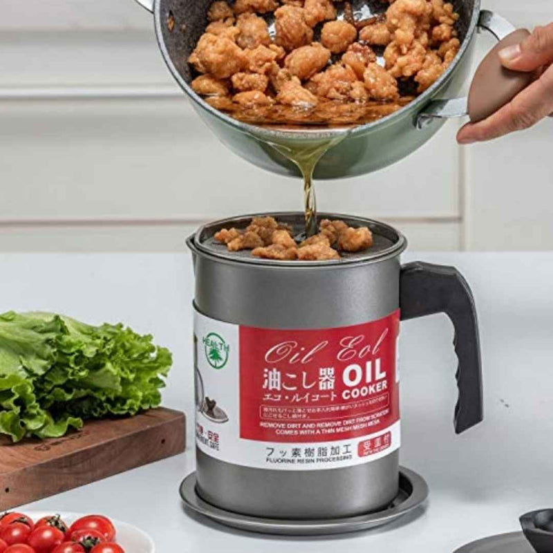 Oil Cooker being used to drain oil from fried food on a kitchen counter.
