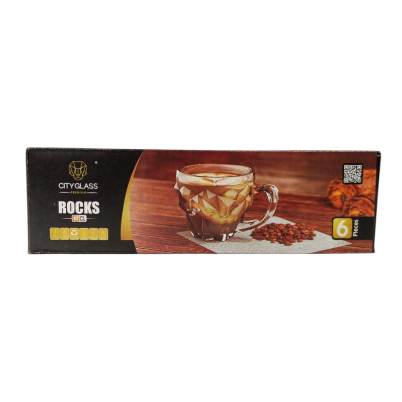 Box of City Glass Rocks glasses with a glass of coffee and coffee beans on a wooden surface.