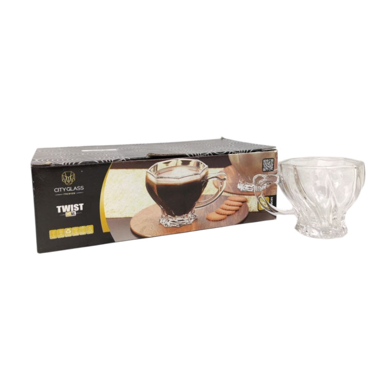 Clear glass mug with handle next to its packaging on a white background