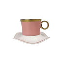 Pink teacup with gold rim and handle on a white saucer against a white background