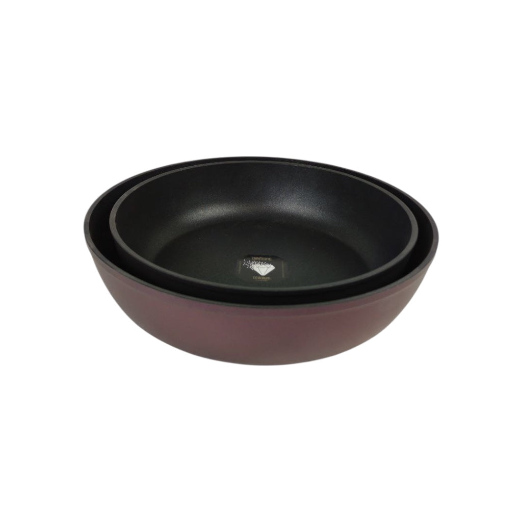 Two black ceramic bowls stacked on a white background