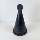 Black cone-shaped kitchen tool on a white background