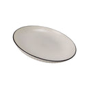 White oval plate with black rim on a white background