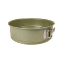 Green metal baking pan with a handle on a white background