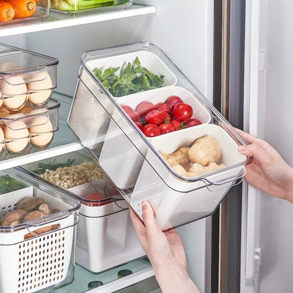 Person using a refrigerator organizer with compartments filled with food items.