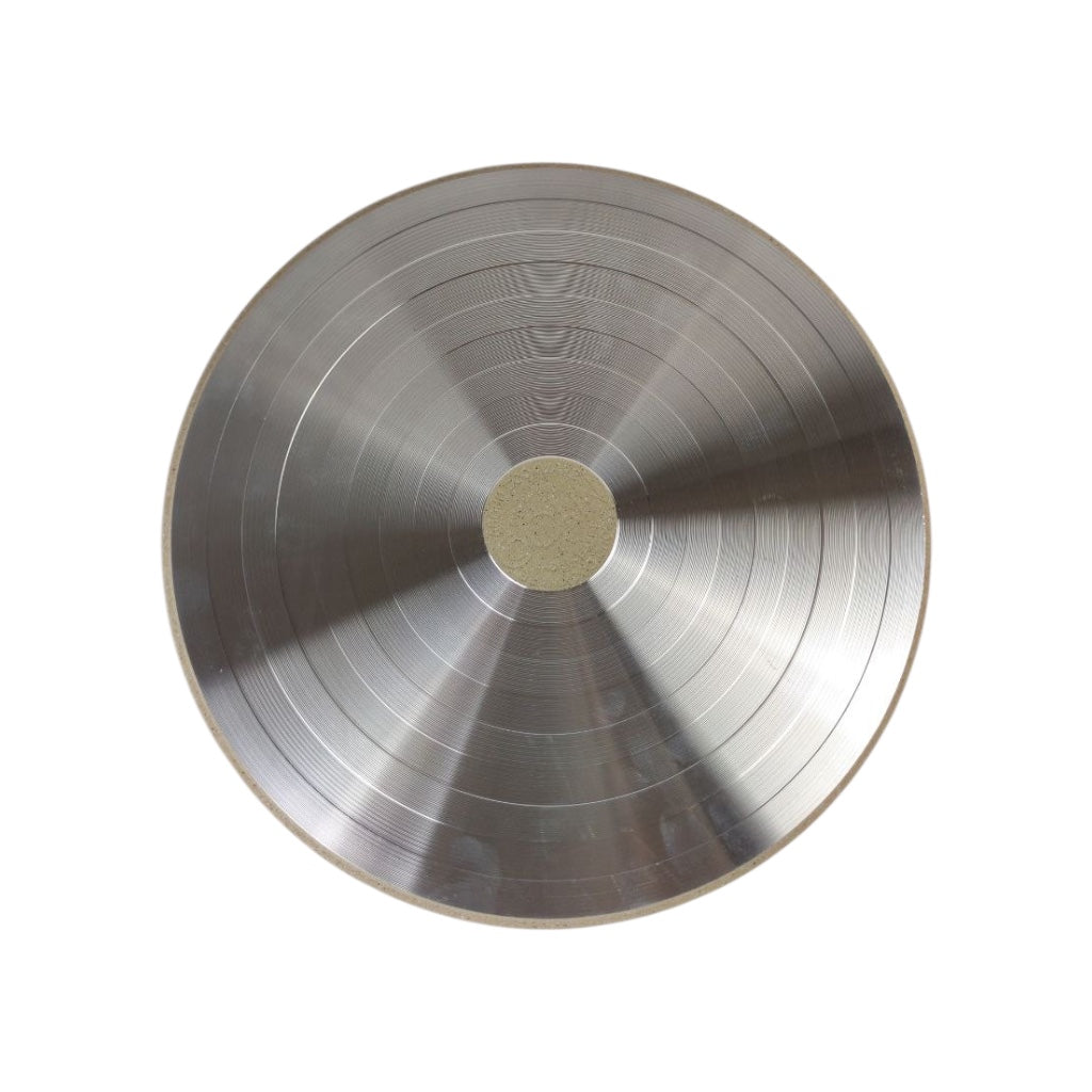 Metallic disc with concentric circles on a white background