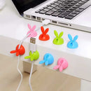 Adhesive cable holders for organizing charging cables on desk