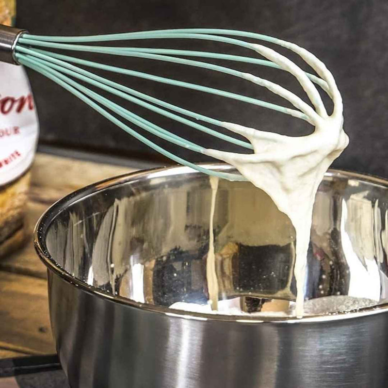 Whisk with cream over a pot on a wooden surface available at cupindy.com
