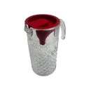 Clear glass pitcher with a red lid on a white background