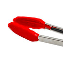 Close-up of red heat-resistant silicone tips on stainless steel kitchen tong, showing grip texture and cooking safety design