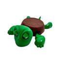 Toy turtle with a green head and brown shell on a white background