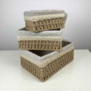 Stack of woven baskets with concrete bases on a white surface