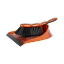 An orange dustpan with a black brush attached to it, designed for cleaning surfaces.