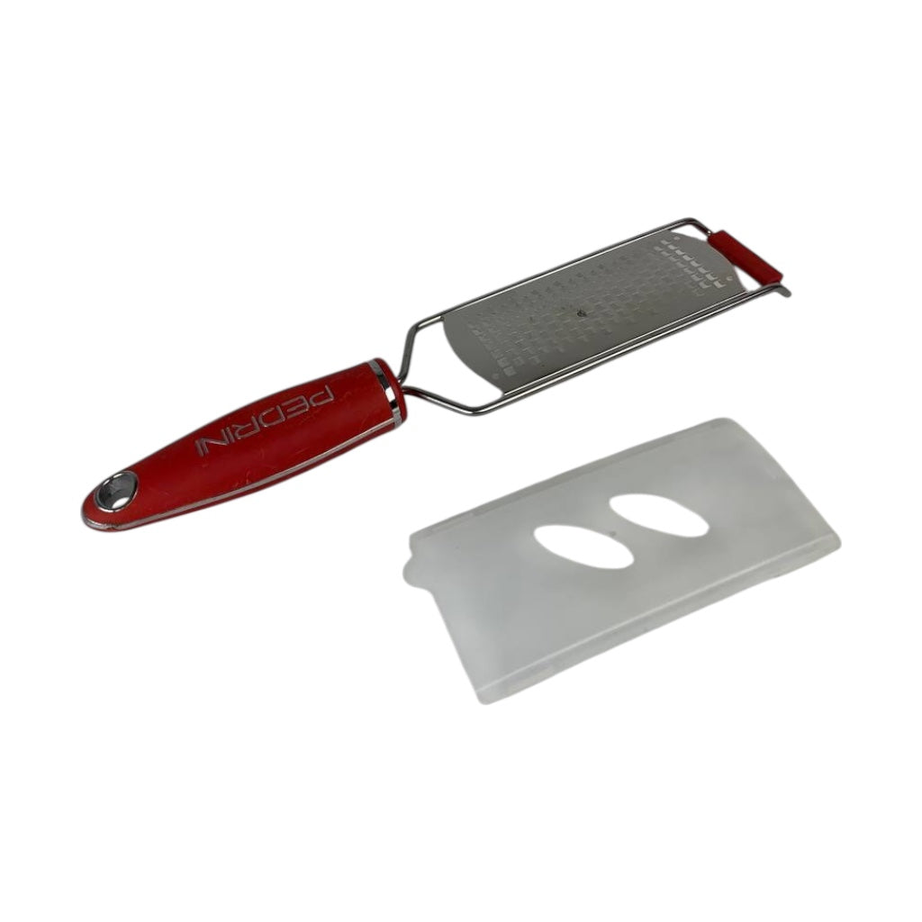 Red zester with a detachable blade on a white background