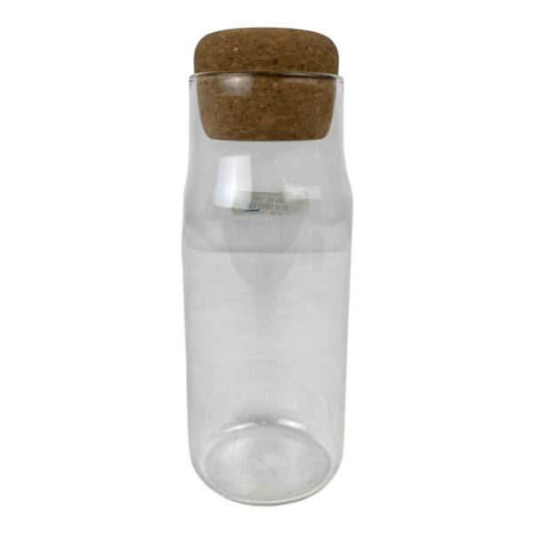 Clear glass bottle with a cork lid on a white background
