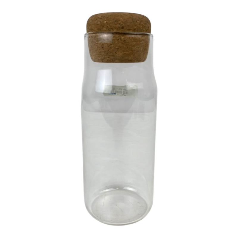 Clear glass bottle with a cork lid on a white background