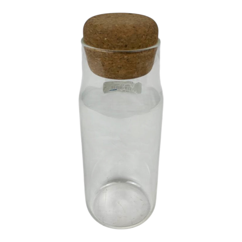 Clear glass bottle with a cork lid on a white background