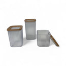 Set of three transparent storage containers with brown lids on a white background