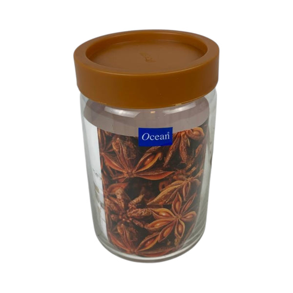 Glass jar with a brown lid filled with star anise, branded 'Ocean'.