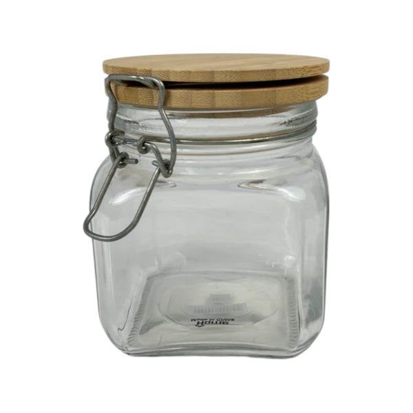 Clear glass jar with a wooden lid on a white background