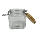 Clear glass jar with a wooden lid on a white background