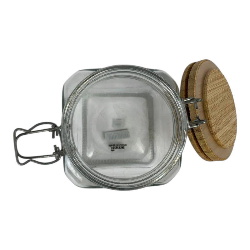 Glass jar with a wooden lid on a white background