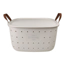 White storage basket with brown handles on a white background