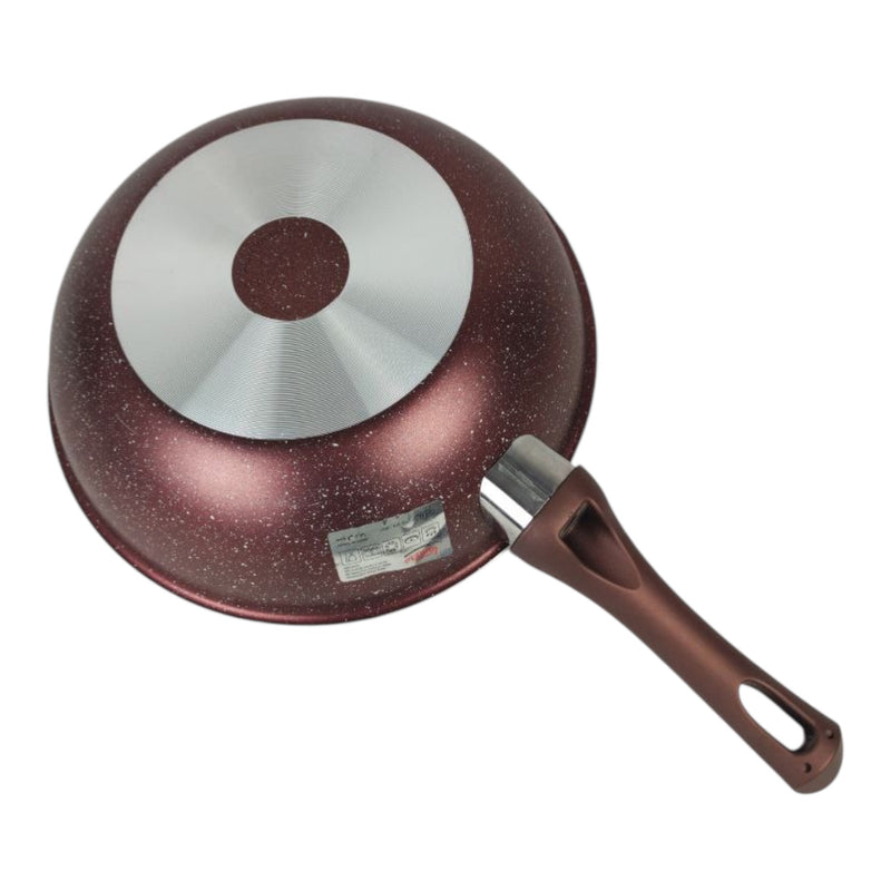 Red speckled frying pan with a silver interior on a white background