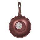 Red speckled frying pan with a brand label on a white background