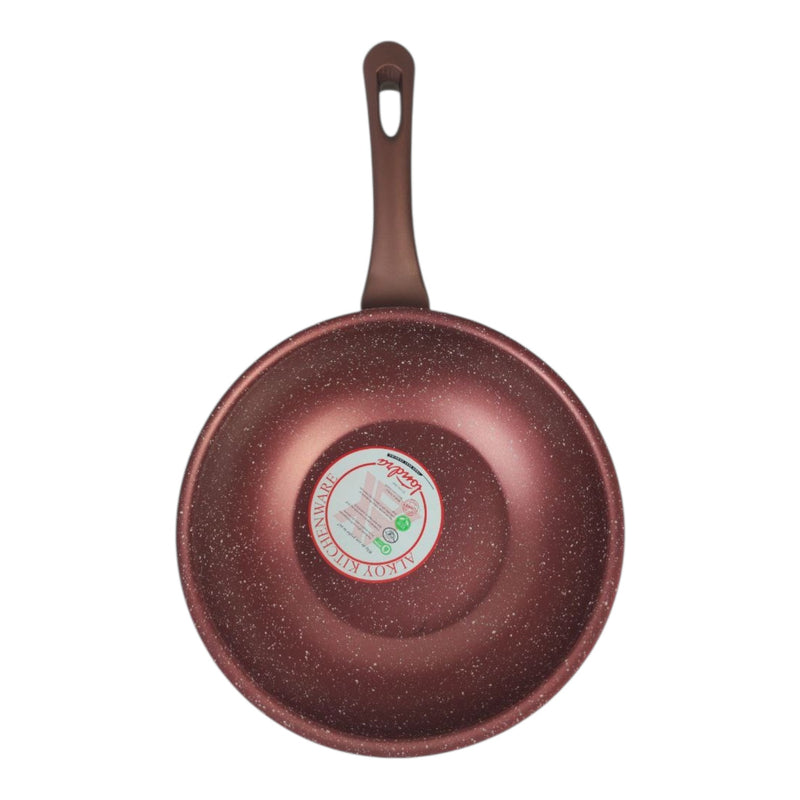 Red speckled frying pan with a brand label on a white background