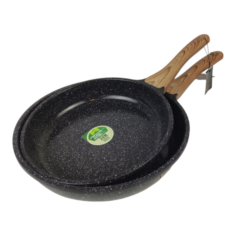 Two black speckled frying pans with wooden handles on a white background